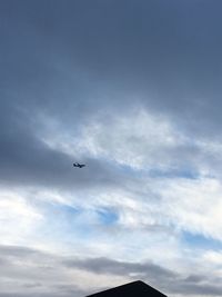 Low angle view of airplane flying in sky