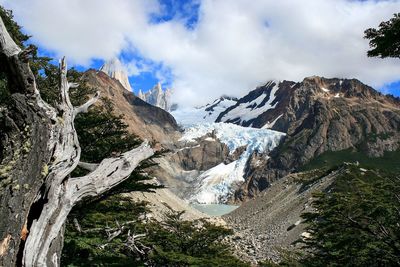 Scenic view of mountains against cloudy sky