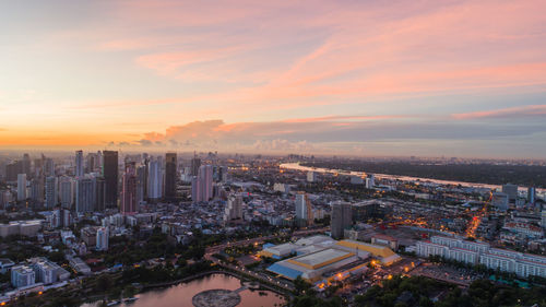 High angle view of modern buildings against sky during sunset