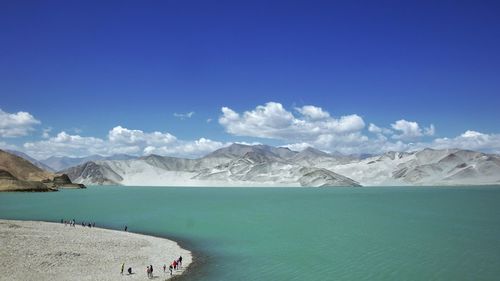 Scenic view of snowcapped mountains against blue sky