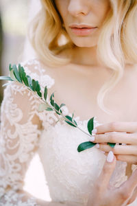 Close-up of young woman holding bouquet
