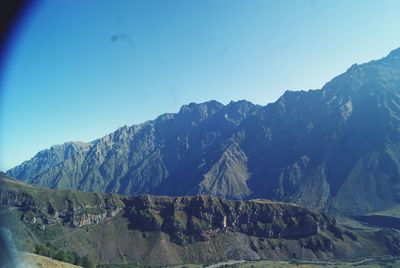 Scenic view of mountains against clear blue sky