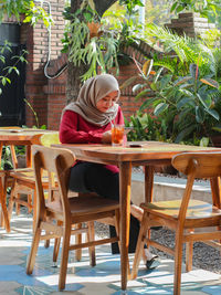 Woman sitting on table