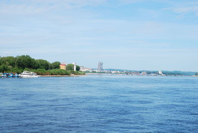 Scenic view of sea against sky in city