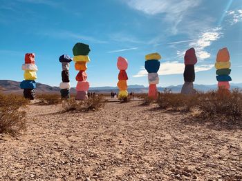 Multi colored rocks on field against sky