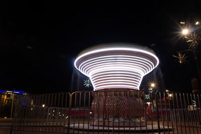 Light trails in amusement park at night