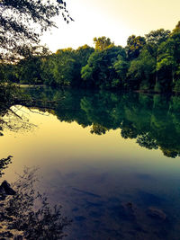 Scenic view of lake against sky at sunset