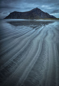 Surface level of sandy beach against sky