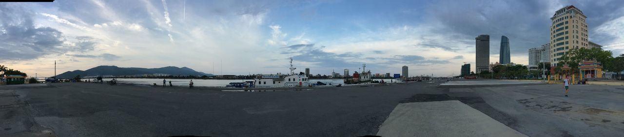 sky, panoramic, cloud - sky, water, transportation, sea, beach, cloud, road, incidental people, building exterior, built structure, cloudy, the way forward, architecture, car, mode of transport, street, day, nature