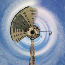 Low angle view of tower against cloudy sky