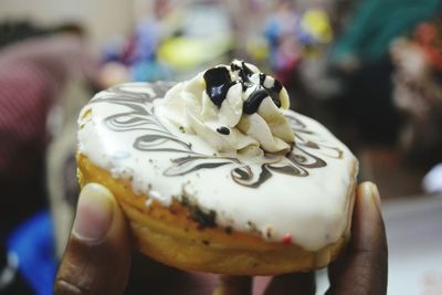 Close-up of hand holding donut