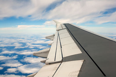 Low angle view of airplane flying against sky