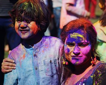 Mother and son with powder paint on faces during holi