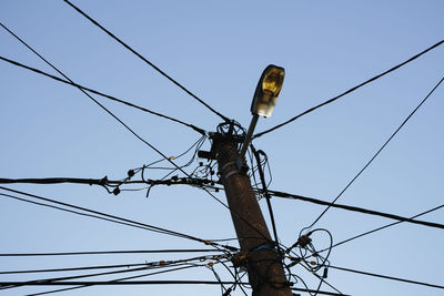 Low angle view of electricity pylon against sky