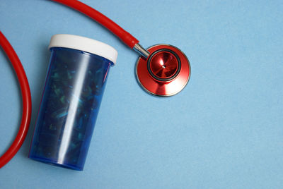 High angle view of drinking glass on table against blue background