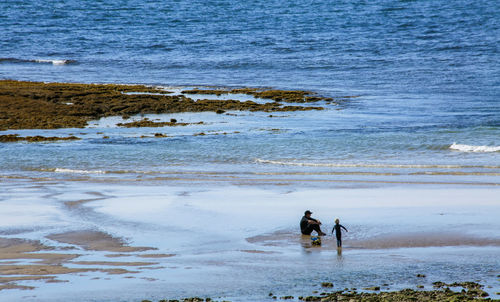 People on beach by sea