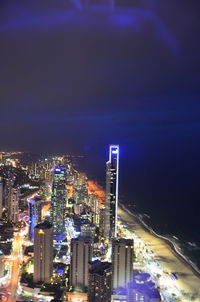 High angle view of illuminated buildings against sky at night