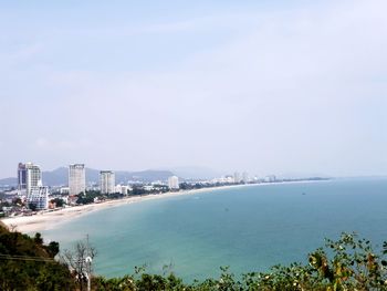 High angle view of sea and buildings against sky