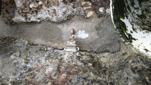 High angle view of statue on rock