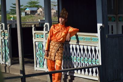 Woman standing by railing