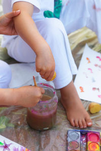 Close-up of children with watercolor paints