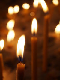 Close-up of illuminated burning candles