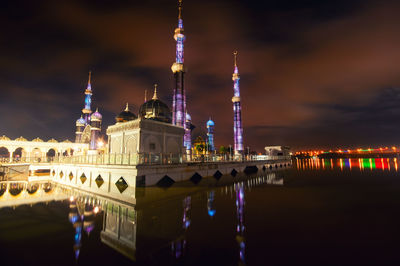 Illuminated temple against sky at night