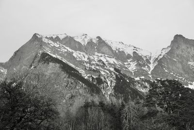 Scenic view of snowcapped mountains against clear sky