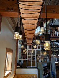 Low angle view of illuminated pendant lights hanging in restaurant