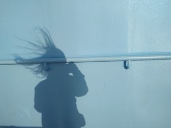 Side view of silhouette man standing against wall