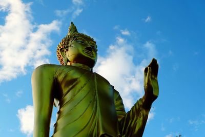 Low angle view of buddha statue against the sky