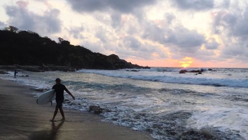 Scenic view of beach against sky during sunset