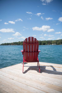 Lifeguard chair on beach against sky