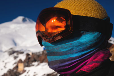 Portrait of a skier at a ski resort against the backdrop of mountains and blue sky. winter sports