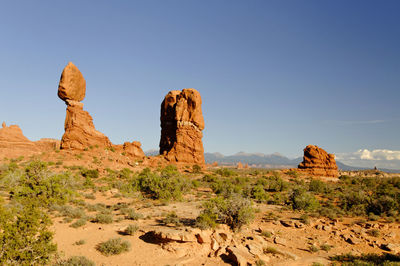 Rock formations on landscape against sky