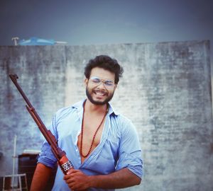 Portrait of smiling young man standing outdoors