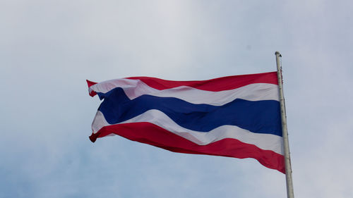 Low angle view of flags flag against sky