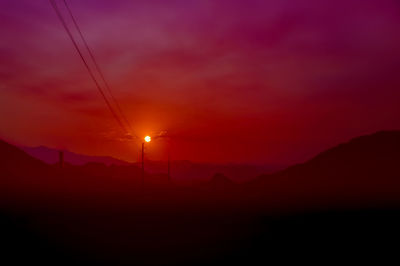 Silhouette landscape against scenic sky