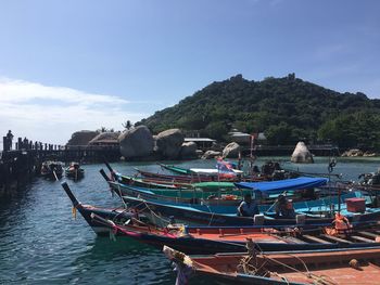 Boats moored on sea against sky