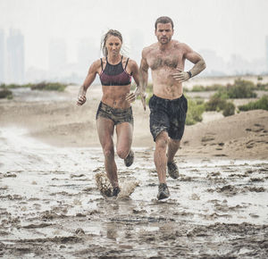 Full length of a smiling young couple on beach