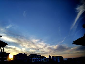 Low angle view of silhouette buildings against sky