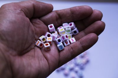 Close-up of cropped hand holding blocks with numbers