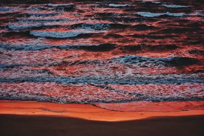 Atlantic ocean waves in red sunrise light on fuerteventura canary island in spain