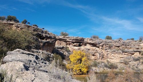 Scenic view of rocky mountains against blue sky