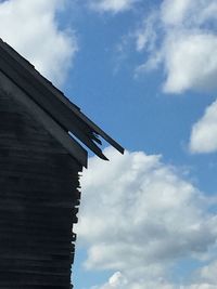 Low angle view of building against cloudy sky