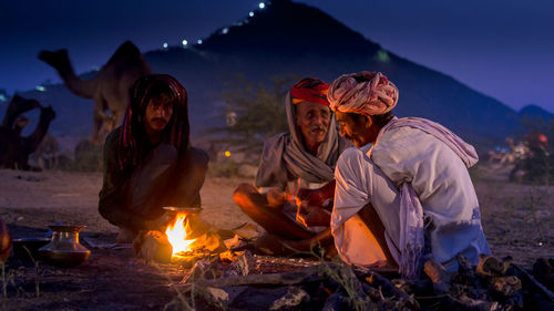 Group of man preparing food at beach