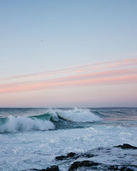 Scenic view of sea against clear sky during sunset