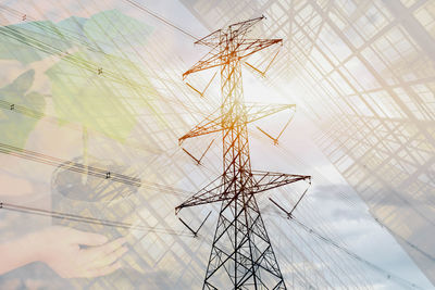 Low angle view of electricity pylon against sky