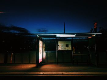 Illuminated bus against sky at night