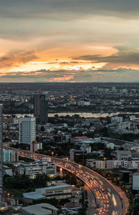 High angle view of road by buildings against sky during sunset